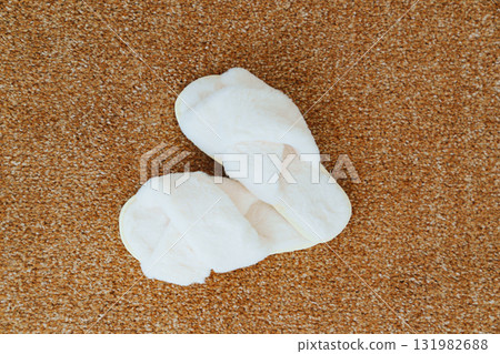 soft white slippers on the beige Interior pile carpet. 131982688