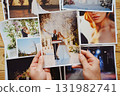 Men's hands put on the table and show wedding photos. 131982741