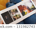 Female hands flipping through a photo book with wedding photos 131982743