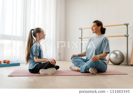 girl doing exercises under doctor's supervision 131983345