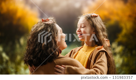 Mother and child daughter on autumn walk Mother and child daughter on autumn walk 131983357