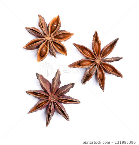 Star anise fruits and seeds, on white background. Illicium verum, also known as badian, Chinese star anise, or star aniseed, a spice that closely resembles anise in flavor. Close-up, from above. Photo Star anise fruits and seeds, on white background. Illicium verum, also known as badian, Chinese star anise, or star aniseed, a spice that closely resembles anise in flavor. Close-up, from above. Photo 131983396