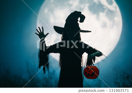 Girl dressed in witch costumes for Halloween Girl dressed in witch costumes for Halloween 131983571