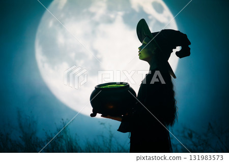 Girl dressed in witch costumes for Halloween 131983573