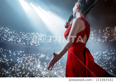 A singer on stage with a microphone 131983581