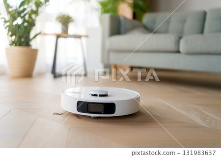 White robotic vacuum cleaner on wooden floor 131983637