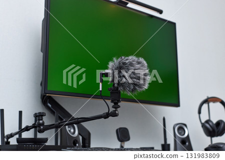 black professional boom microphone stand used for recording voice in online podcast in home studio. fluffy microphone and computer on the table 131983809