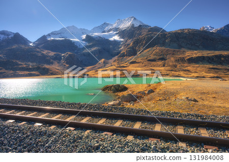 Scenic railway tracks running along turquoise lake Bianco Scenic railway tracks running along turquoise lake Bianco 131984008