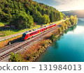 Aerial view of red modern high speed train moving near river 131984013