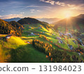 Aerial view of green alpine valley at sunset with villages 131984023