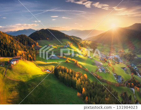 Aerial view of green alpine valley at sunset with villages 131984023