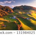 Aerial view of green alpine valley at sunset with villages 131984025
