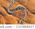 Aerial view of winding road in mountain pass at sunset in autumn 131984027