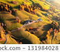 Aerial view of green alpine valley at sunset with villages 131984028