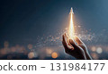 Hands launching a glowing rocket into the sky, concept of startup growth, innovation and business success 131984177