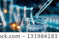 Close-up of pipette dripping clear liquid into glass beaker, concept of scientific research and laboratory experiment 131984183