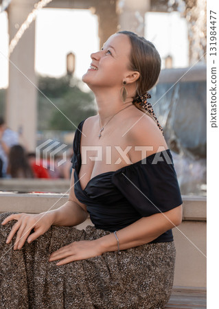 Woman Smiling Fountain Cityscape - Portrait of a young woman smiling at a fountain in a city. Woman Smiling Fountain Cityscape - Portrait of a young woman smiling at a fountain in a city. 131984477