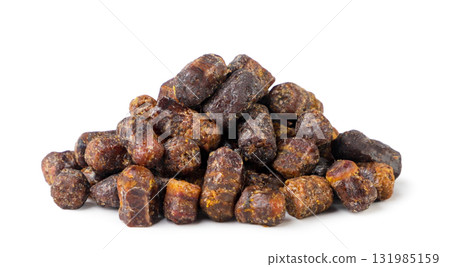 Pile of bee bread granules close-up on a white background. Isolated 131985159
