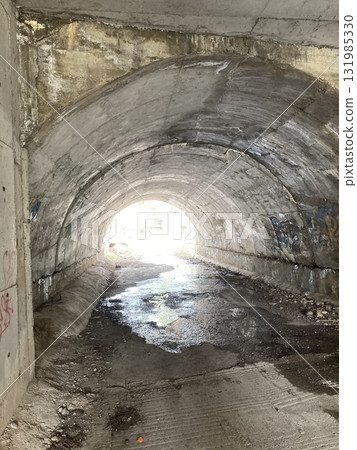 An old tunnel under the road at the other end you can see the sun An old tunnel under the road at the other end you can see the sun 131985330