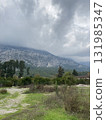 Low fluffy clouds hang over the high mountains, cover their peaks 131985347