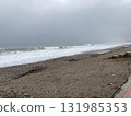 The turbulent sea storms the shore of sand mixed with pebbles 131985353