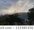 Low fluffy clouds hang over the high mountains, cover their peaks 131985356