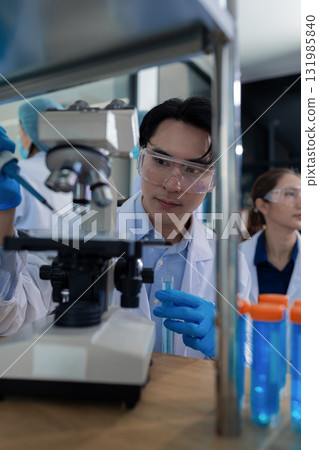 Lab work, Doctor holds a test tube takes the test from a test tube in analysis, blood, DNA, test tube stand. 131985840