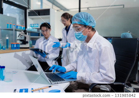 Lab work, Doctor holds a test tube takes the test from a test tube in analysis, blood, DNA, test tube stand. Lab work, Doctor holds a test tube takes the test from a test tube in analysis, blood, DNA, test tube stand. 131985842