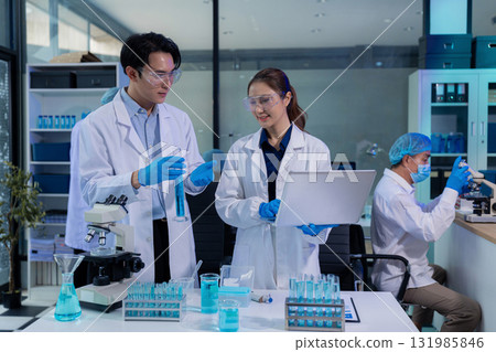 Lab work, Doctor holds a test tube takes the test from a test tube in analysis, blood, DNA, test tube stand. Lab work, Doctor holds a test tube takes the test from a test tube in analysis, blood, DNA, test tube stand. 131985846