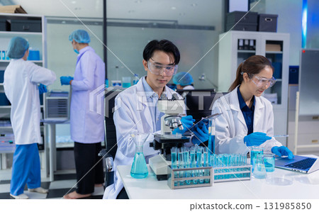 Lab work, Doctor holds a test tube takes the test from a test tube in analysis, blood, DNA, test tube stand. 131985850