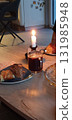 Homemade mulled wine with apple pastries on a cozy fall evening at home, mobile photo. Perfect for illustrating seasonal food, autumn atmosphere, and cozy lifestyle scenes. 131985948