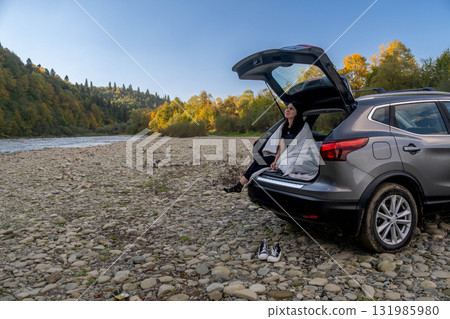 Woman Relaxing in Car Trunk in Nature 131985980