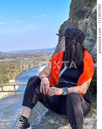 Person Enjoying Scenic View from Rocky Cliff Person Enjoying Scenic View from Rocky Cliff 131985988