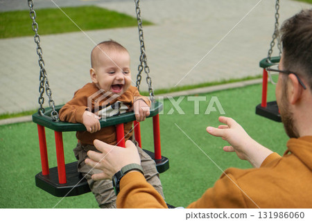 Father and Baby Enjoying Swing Time 131986060