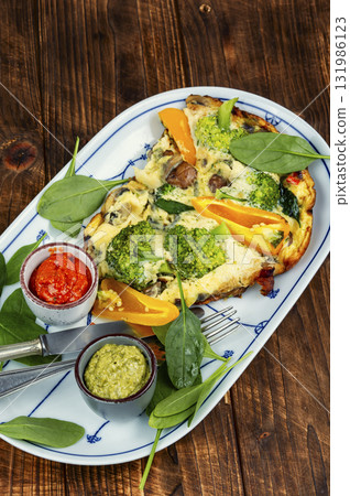 Vegetable egg omelette on a plate. 131986123