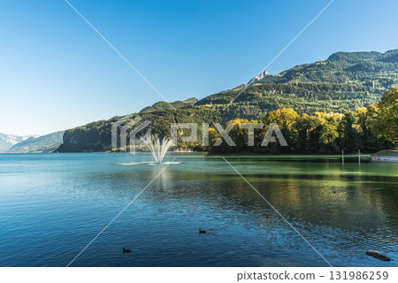 Lake Walensee with fountain, Weesen, Canton of St. Gallen, Switzerland 131986259