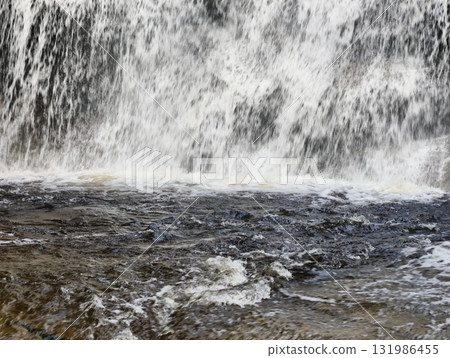 Majestic Waterfall Powerfully Surging Over Rocks in the Heart of Natures Stunning Beauty Majestic Waterfall Powerfully Surging Over Rocks in the Heart of Natures Stunning Beauty 131986455