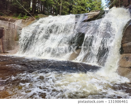 A Tranquil Waterfall Nested in a Beautiful Lush Green Forest Setting with Natures Wonders 131986461