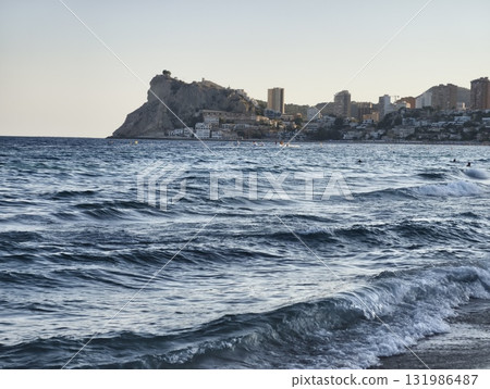 Coastal Serenity Captivating Waves and Urban Cityscape at Dusk Under a Beautiful Sky 131986487