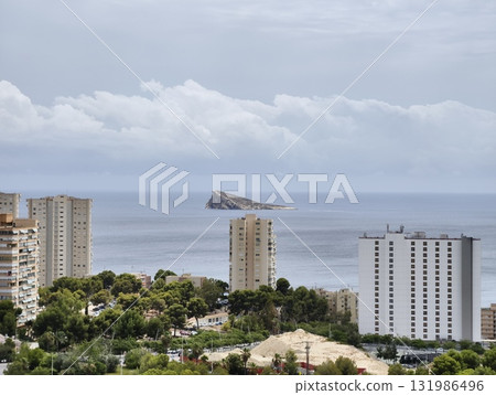 A stunning scenic coastal view featuring a unique rock formation alongside a vibrant cityscape A stunning scenic coastal view featuring a unique rock formation alongside a vibrant cityscape 131986496