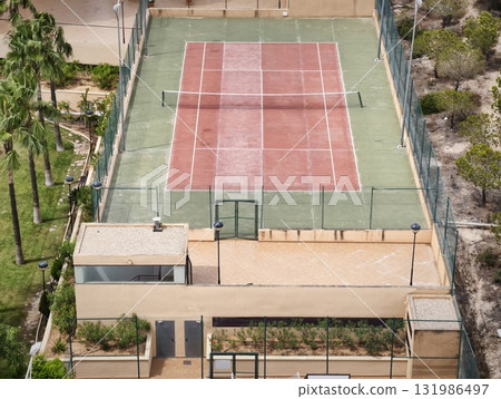 Stunning Aerial View of a Tennis Court Immersed in Beautiful Lush Landscaping All Around Stunning Aerial View of a Tennis Court Immersed in Beautiful Lush Landscaping All Around 131986497