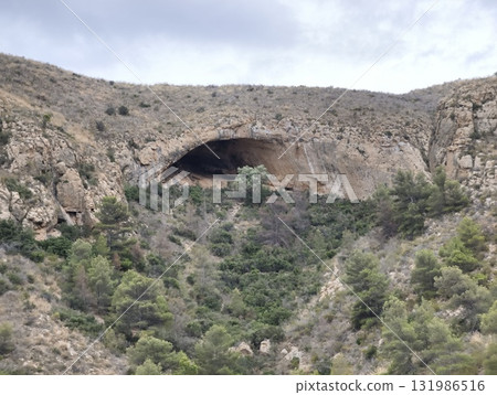 Explore the Majestic Natural Cave in the beautiful Rocky Landscape, perfect for adventurers Explore the Majestic Natural Cave in the beautiful Rocky Landscape, perfect for adventurers 131986516