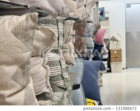 A store aisle filled with neatly stacked decorative pillows in various colors, patterns, and textures A store aisle filled with neatly stacked decorative pillows in various colors, patterns, and textures 131986672
