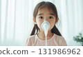 Asian little girl sick and doing inhalation in house 131986962