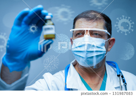 Healthcare professional examines vaccine vial in laboratory setting during pandemic 131987083