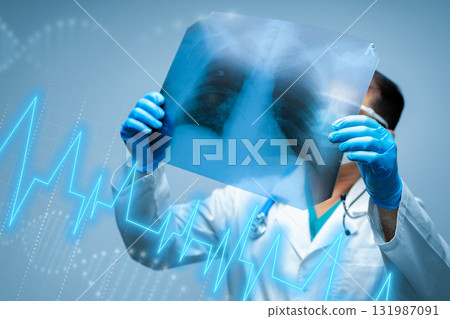 Doctor examines lung X-ray with digital health data display in a modern medical setting Doctor examines lung X-ray with digital health data display in a modern medical setting 131987091