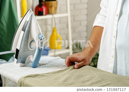Ironing clothes at home to achieve a polished look for daily wear Ironing clothes at home to achieve a polished look for daily wear 131987117