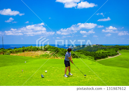 A golfer hitting a driver on a hole over the sea at a tropical resort golf course (Miyakojima City, Okinawa Prefecture) A golfer hitting a driver on a hole over the sea at a tropical resort golf course (Miyakojima City, Okinawa Prefecture) 131987612