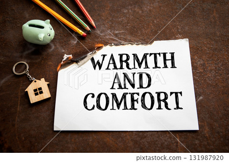 Warmth and comfort concept with burning paper showing text warmth and comfort 131987920