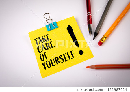 Take care of yourself concept with yellow note paper and stationery on desk. Symbol of health 131987924